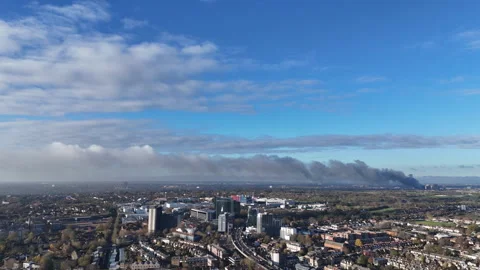 Aerial view pulling away from smoke over Hounslow, London Stock Footage 323680895