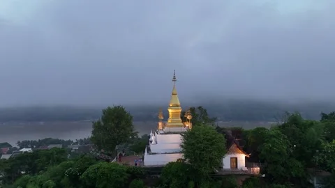 Aerial View Pulling Back From Golden Stupa on Misty Hilltop, Luang Prabang Stock-Footage 347422534