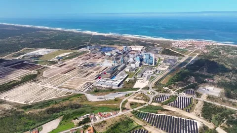 Aerial view of a pulp mill and solar panel farm on the coast Stock Footage 340311930