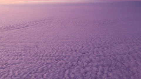 Aerial view of purple sunset clouds from an aircraft. Video stock 61493528