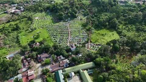 Aerial view of a quarry lake surrounded by lush greenery and mountains Stock Footage 334646642