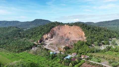 Aerial view of a quarry lake surrounded by lush greenery and mountains Stock Footage 334646738