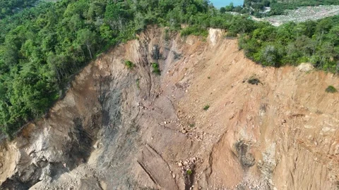 Aerial view of a quarry lake surrounded by lush greenery and mountains Stock Footage 334646941