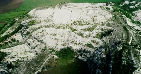 Aerial view of a quarry with a lonely tree on top of it. Stock Footage 135027149