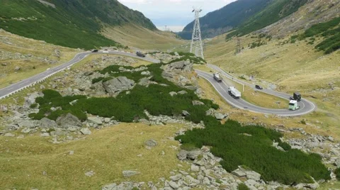 Aerial view on a queue of trucks on the most beautiful road in Europe Stock Footage 61323369