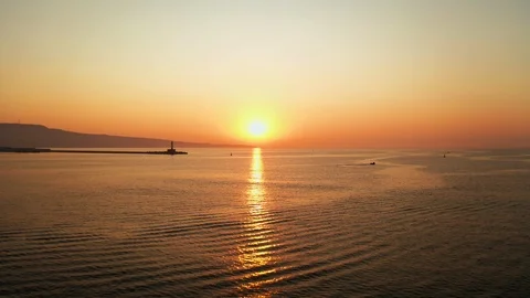 Aerial view of a quick passage forward drone to a panorama sea and sunset sky Stock Footage 119212424