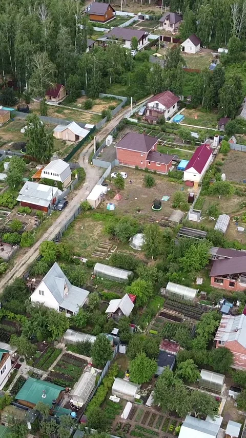 Aerial view of a quiet, tree-lined village Stock-Footage 347498558