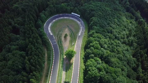 Aerial view of racetrack surrounded by forest Stock Footage 106239499