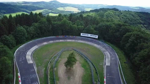 Aerial view of racetrack surrounded by forest Stock Footage 106239627