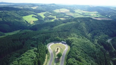 Aerial view of racetrack surrounded by forest Stock Footage 106240212