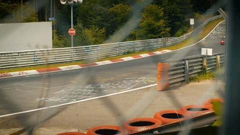 Aerial view of racetrack surrounded by forest. Looking through fence Stock Footage 111425129