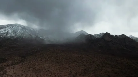 Aerial View of Rain Cloud in Snow Covered Arizona Desert Mountain 4K Stock Footage 154221698