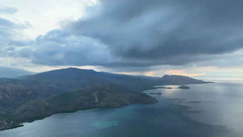 Aerial View of Rain Clouds and Beautiful Islands at Sunset in Indonesia Stock Footage 219695348