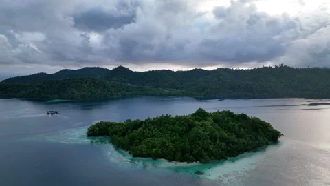 Aerial View of Rain Clouds and Tropical Islands During Sunrise in Raja Ampat Stock Footage 256083819