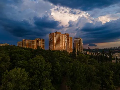 Aerial view on rain clouds at sunset over the city Foto stock