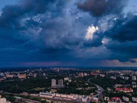 Aerial view on rain clouds at sunset over the city Foto stock