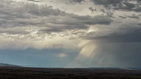 Aerial view of rain shower over mesa landscape, United States. Stock Footage 346604575