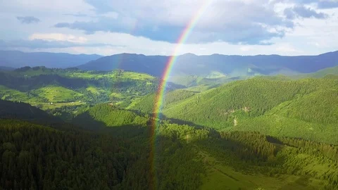 Aerial view of rainbow and rain in the mountains Stock Footage 115354566