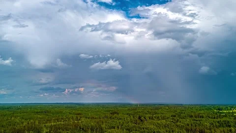 Aerial view of a rainbow over a green forest, Latvia. Stock Footage 339964255