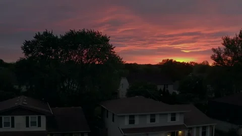 Aerial view of rainbow at sunset flying over neighborhood of houses before the Video stock 171408285