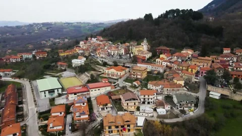 Aerial view of a raised square in a small village with a church and trees 库存影片 149997210