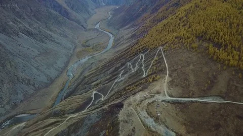 Aerial view rally racing in Siberia on the Altai among the fields and mountains Stock Footage 83307953