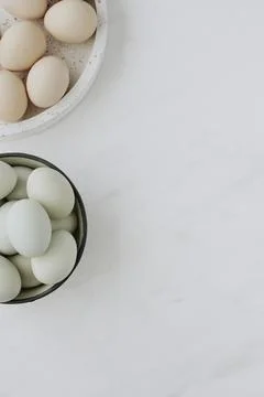 Aerial view of raw eggs on a white marble table Stock Photos