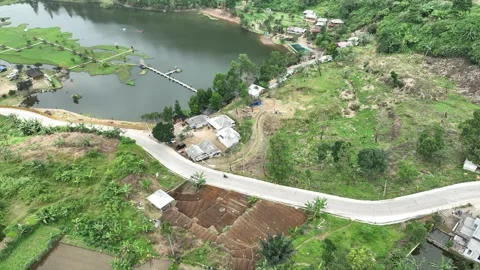 Aerial view of Rawa Gede Jonggol Lake and a winding road, Indonesia. Stock Footage 336380907