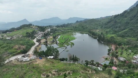 Aerial view of Rawa Gede Jonggol Lake and green hills, Indonesia. Stock Footage 336380989