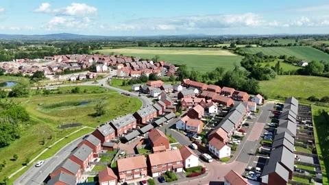 Aerial view of recently built houses with countryside in the background Stock Footage 300039341