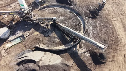 Aerial view of reclaimer machine processing coal at an industrial mining site Stock Footage 339304348