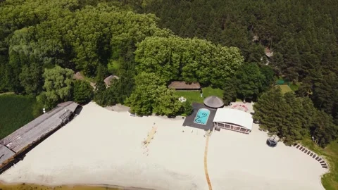 Aerial view of a recreational complex with a riverside pool and a clean white Stock Footage 321944377