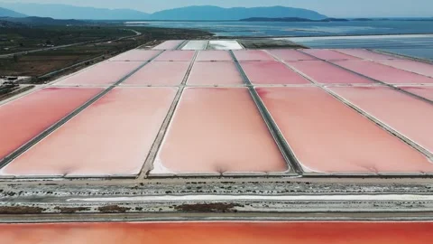 Aerial view of rectangle shape sea salt farm artificial ponds in Albania Stock Footage 261781765