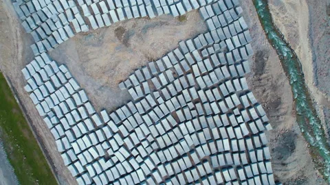Aerial view of rectangular gray concrete building materials on the ground Stockbeeldmateriaal 198747233
