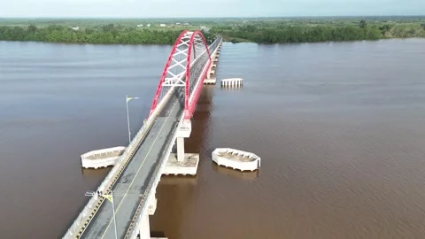 Aerial view of a red and white painted bridge stretching over Stock Footage 327542422