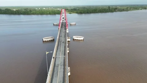 Aerial view of a red and white painted bridge stretching over Stock Footage 327542455