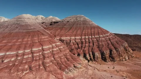 Aerial view of red and white striped rock formations in Altyn Emel Stock Footage 345410063