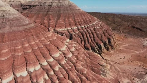 Aerial view of red and white striped sandstone formations in Altyn Emel Stock Footage 345410148