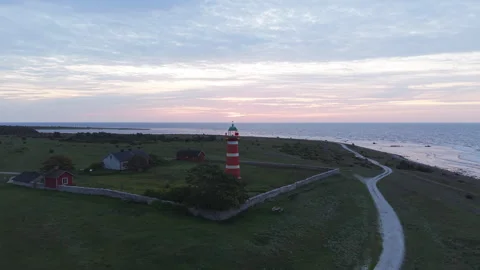 Aerial View of Red and White Lighthouse in Early Morning Light Stock Footage 345933228