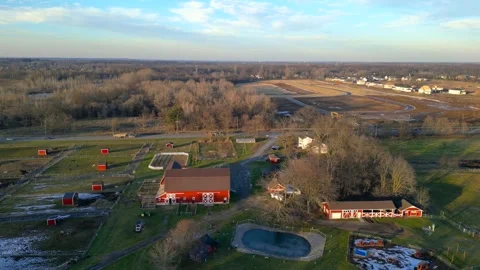 Aerial view of red barn and farm in Michigan countryside in the suburbs of .. Video stock 320204088