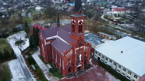 Aerial View of Red Brick Neo Gothic Church in Belarusian Village Stock Footage 316167974