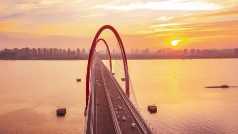 Aerial view of red bridge at sunset over river Stock-Footage 333816145