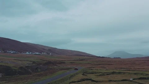 Aerial view of red car moving on beautiful curved costal road Stock Footage 101541654