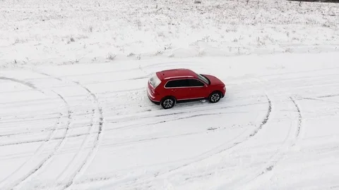 Aerial view of red car standing still on a snowy road. Video stock 78625951