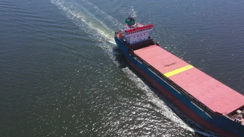 Aerial view of red cargo grain ship floats on the calm sea Stock Footage 178965910