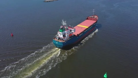 Aerial view of red cargo grain ship floats on the calm sea on warm sunny day Stock Footage 196616185