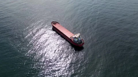 Aerial view of a red cargo ship sailing in the open blue ocean Stock-Footage 332713435