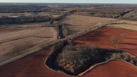 Aerial View of Red Dirt Fields and Creek in Rural Oklahoma Stock Footage 327336654