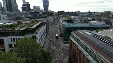 Aerial view of a red double decker bus driving down the street in London, UK Stock Footage 253543103
