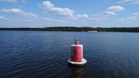 Aerial view. Red floating navigation mark in fairway of a wide navigable river. Stock Footage 97853806